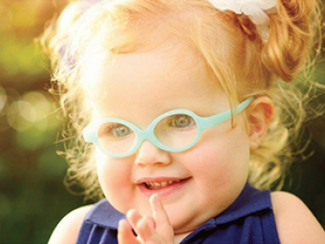 female child with glasses smiling